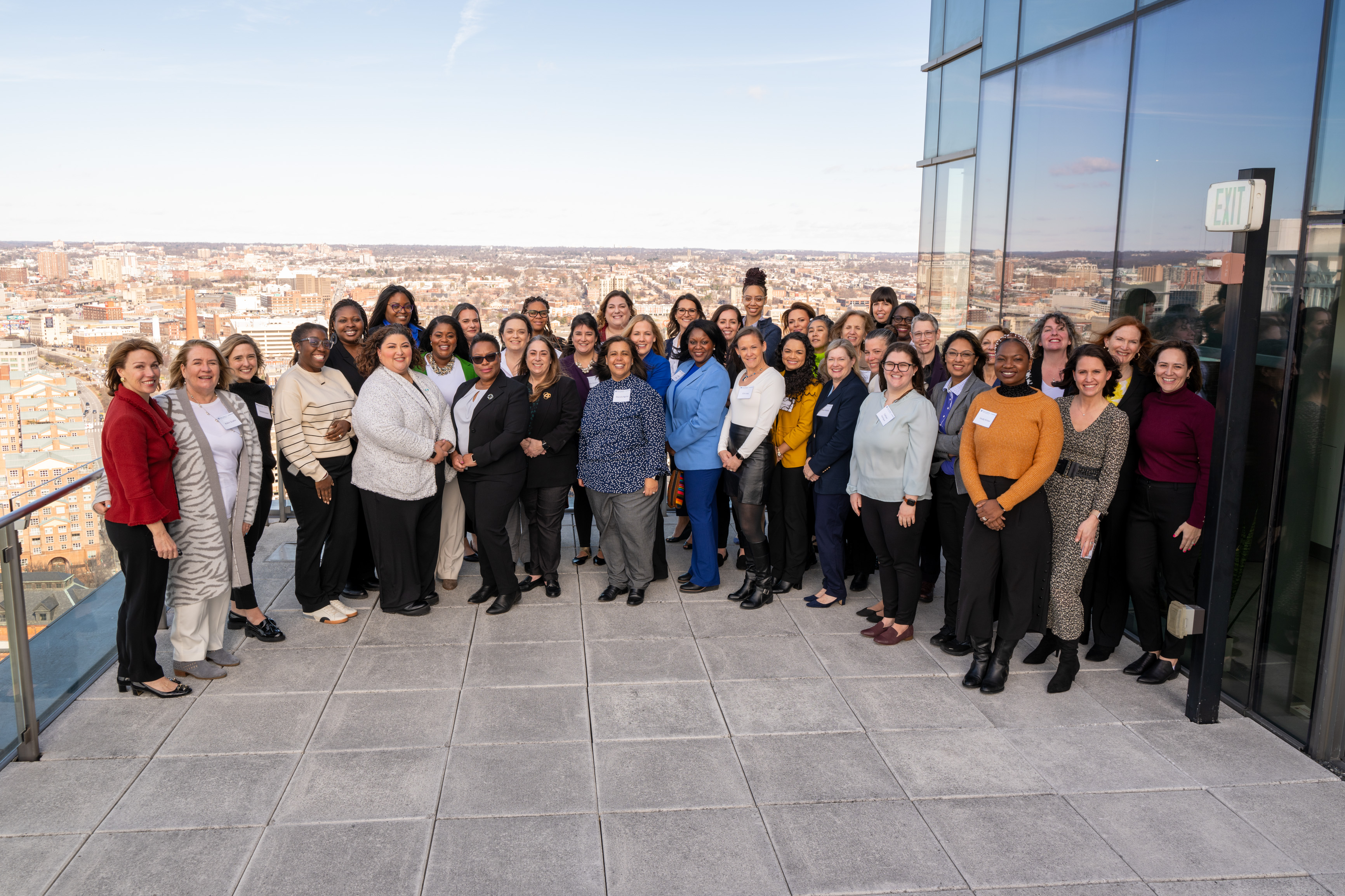 39 women posing for photo outside