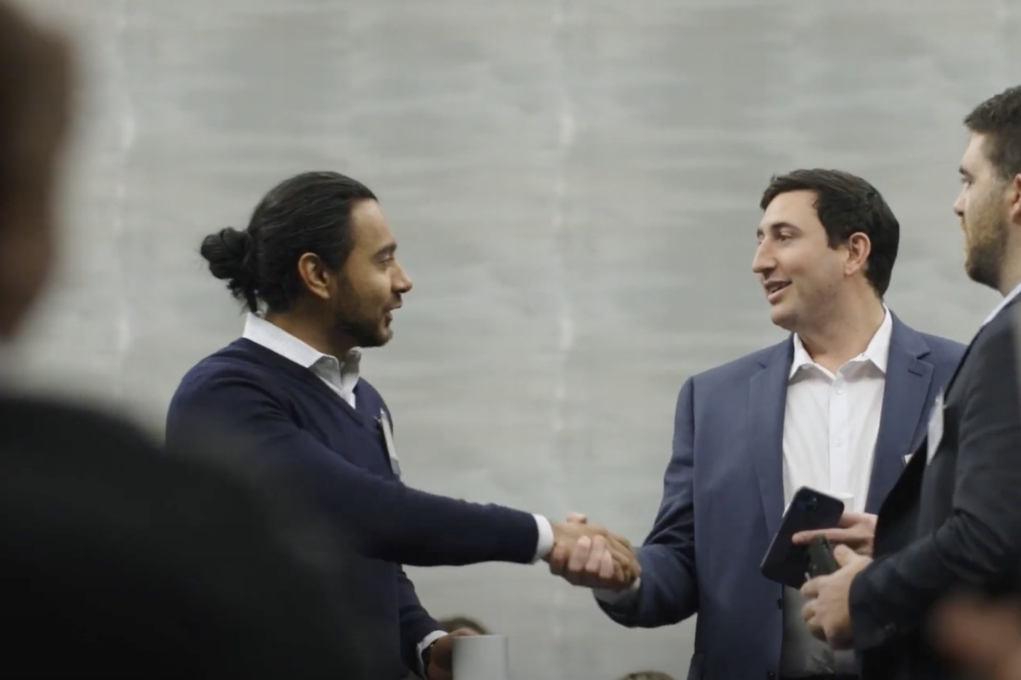 two people standing shaking hands