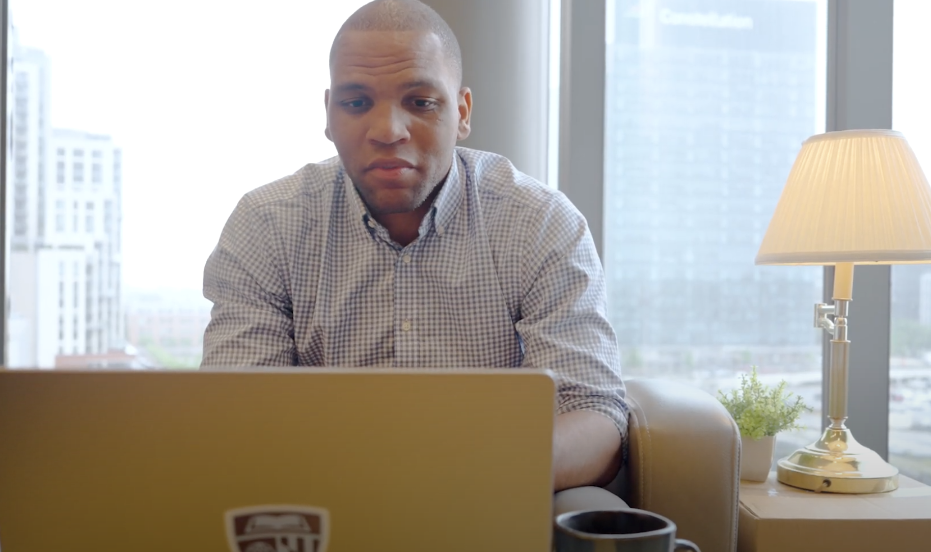 person sitting in a chair typing on a laptop