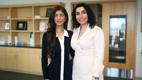 two people standing next to each other posing for a photo
