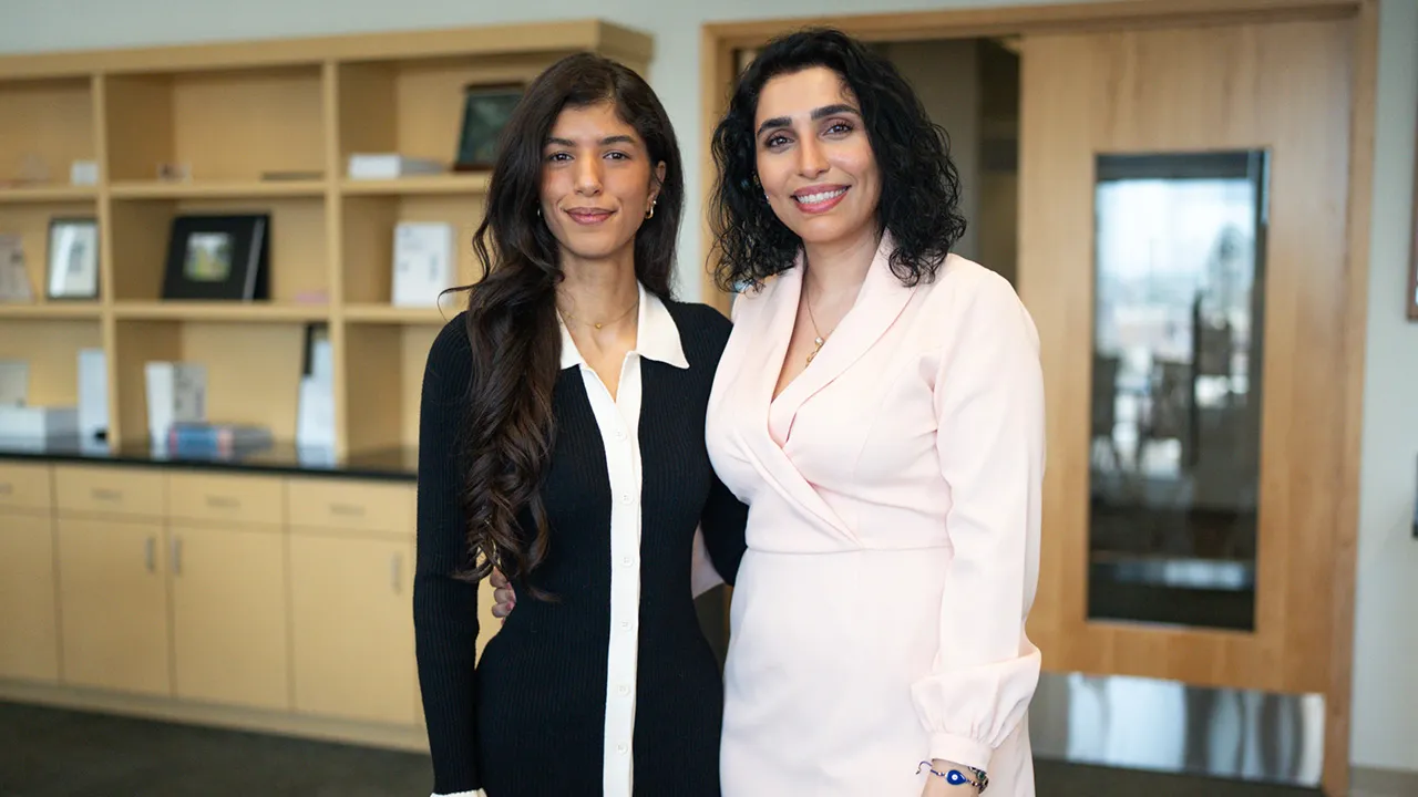two people standing next to each other posing for a photo