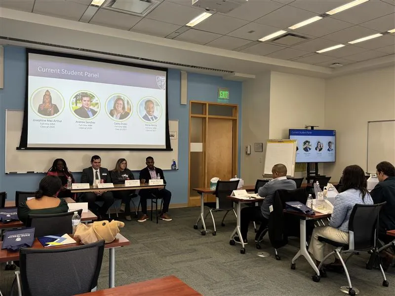panel of people sitting in chairs in the front of a classroom, people sitting listening to them