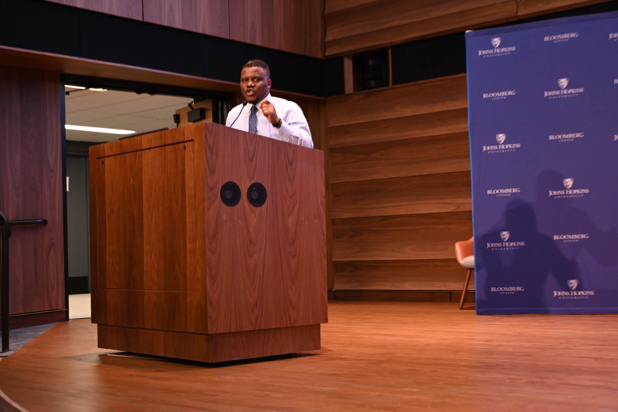 person standing at podium speaking