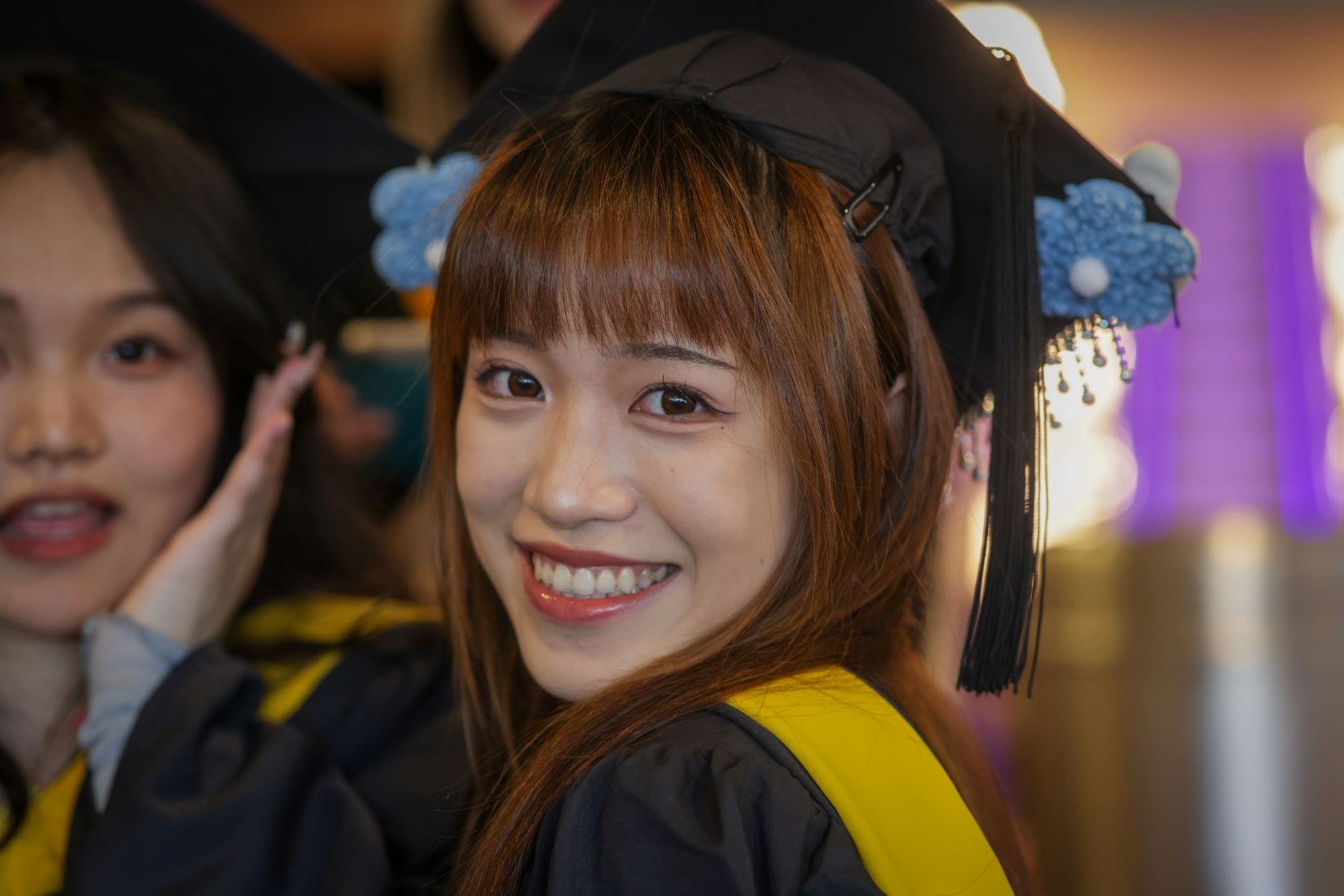 close up photo of person in graduation gap smiling
