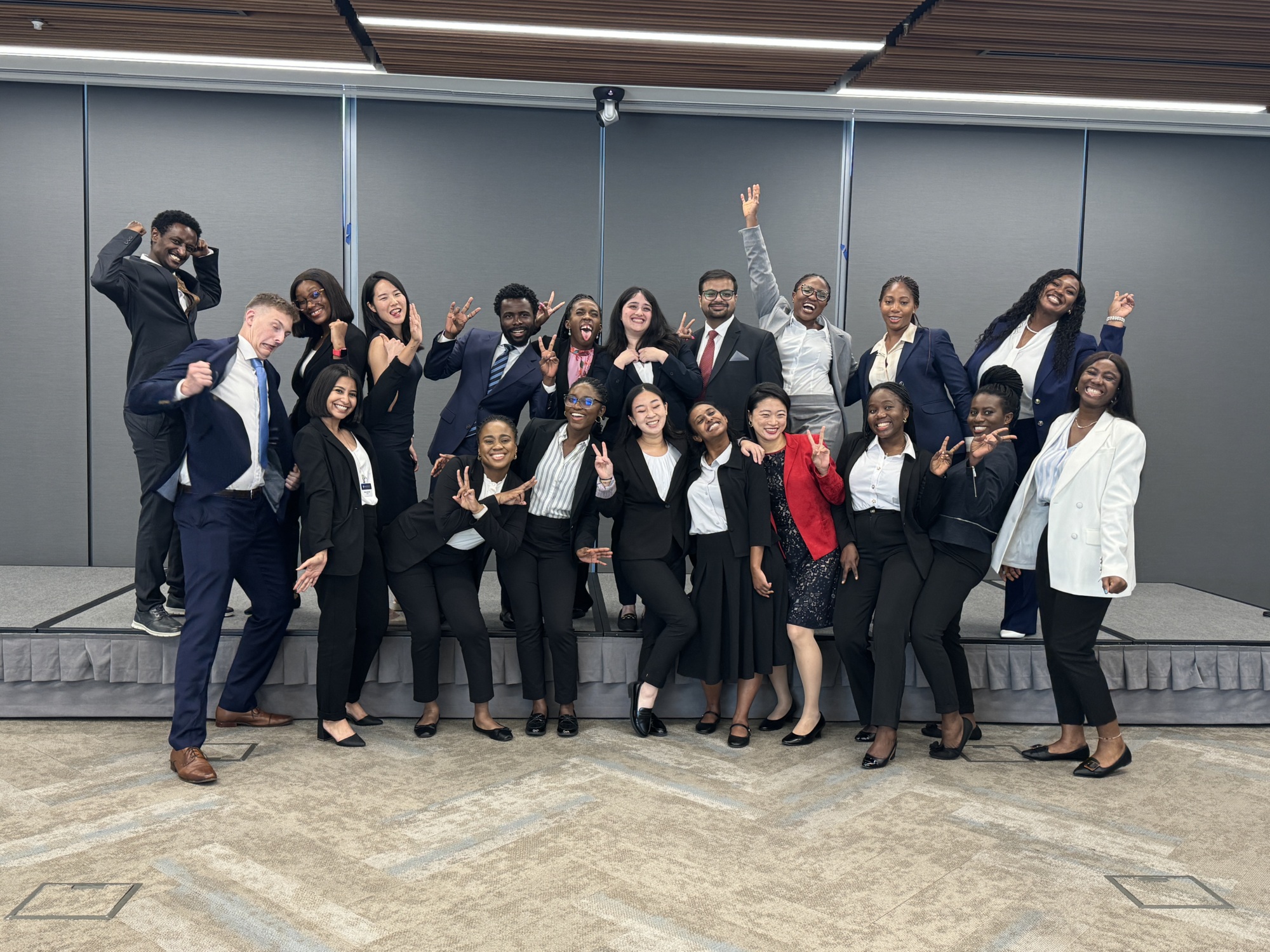 large group photo of people in business attire making silly faces at the camera