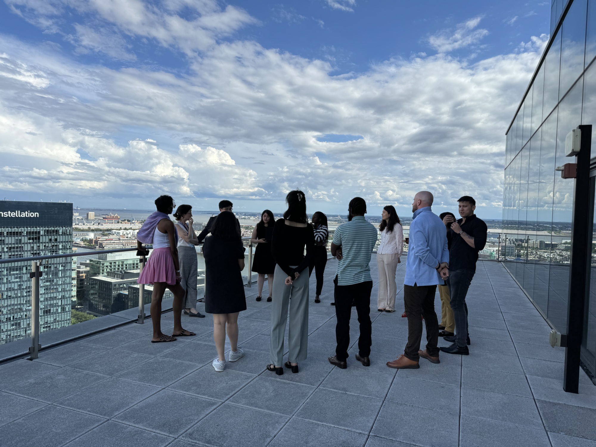 photo taken of the back of people talking outside on a terrace in business attire