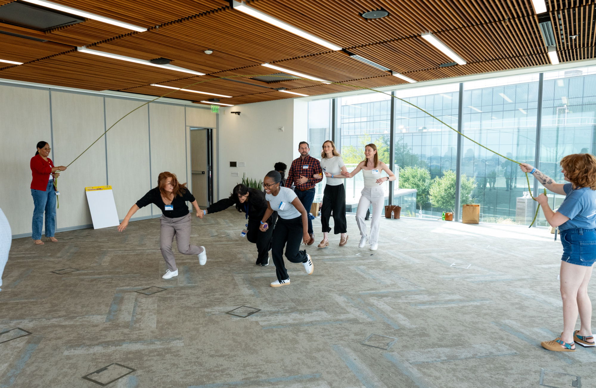 people participating in a jump rope activity. three people featured going under the jump rope