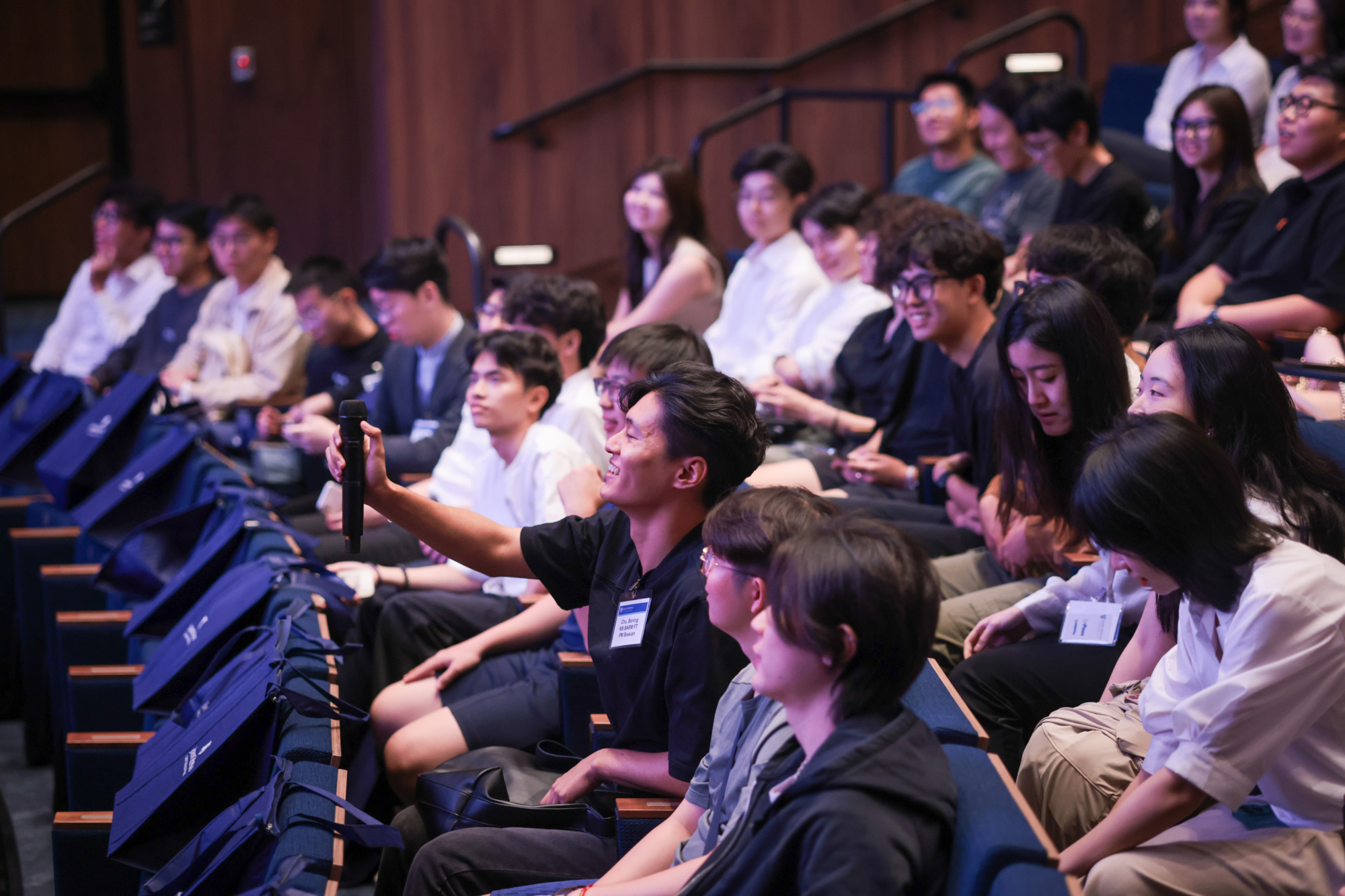 side view of people sitting in an audience