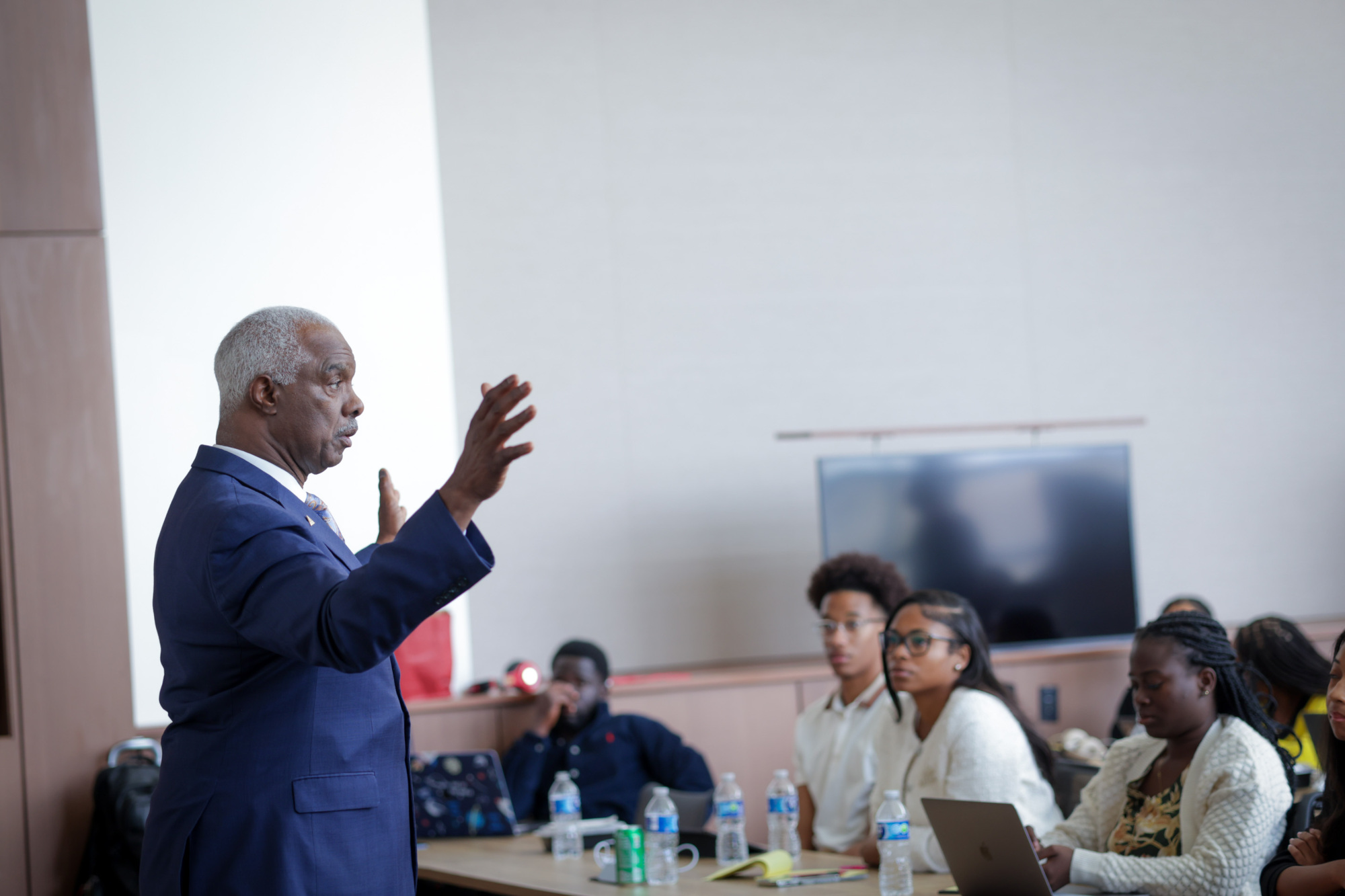 person presenting to students who are sitting at desks